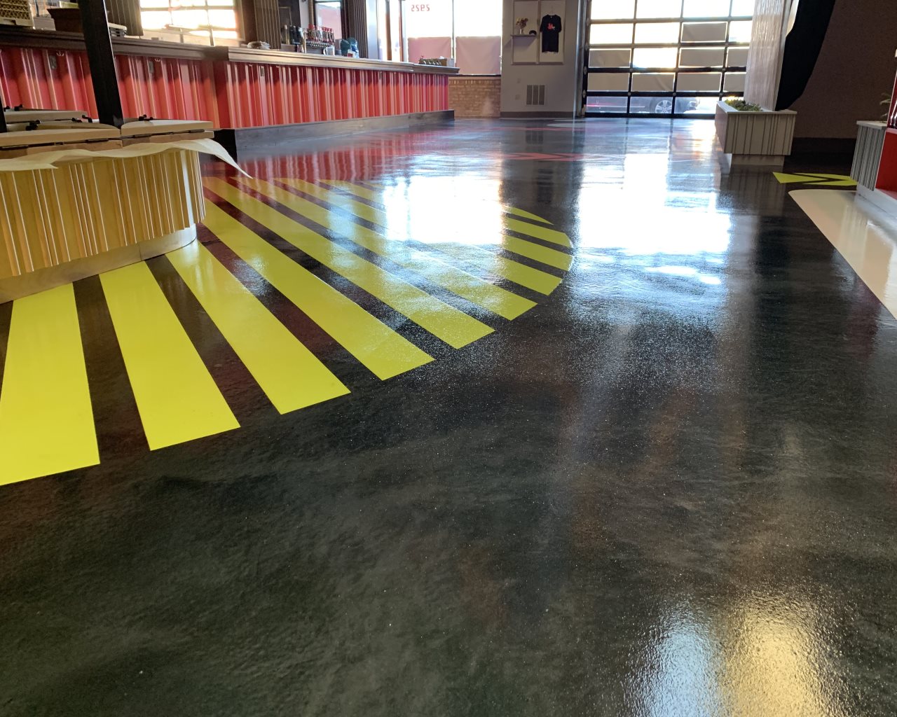 Deep bronze metallic epoxy floor in a narrow office hallway
